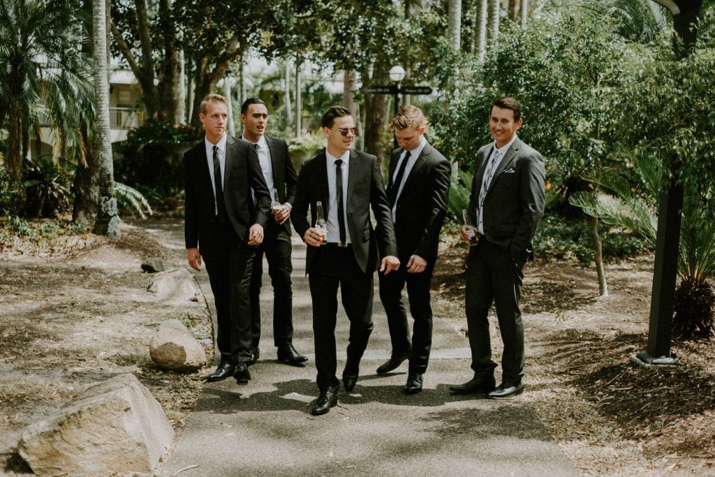 Gold Coast Wedding photographer with groomsmen walking amongst the grounds of the Intercontinental Sanctuary Cove.