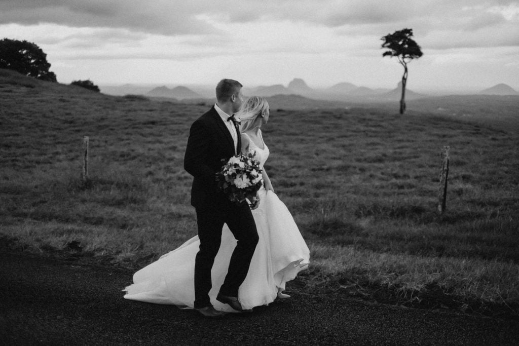Sunshine Coast Wedding photography at one tree hill, couple walking together looking at landscape.