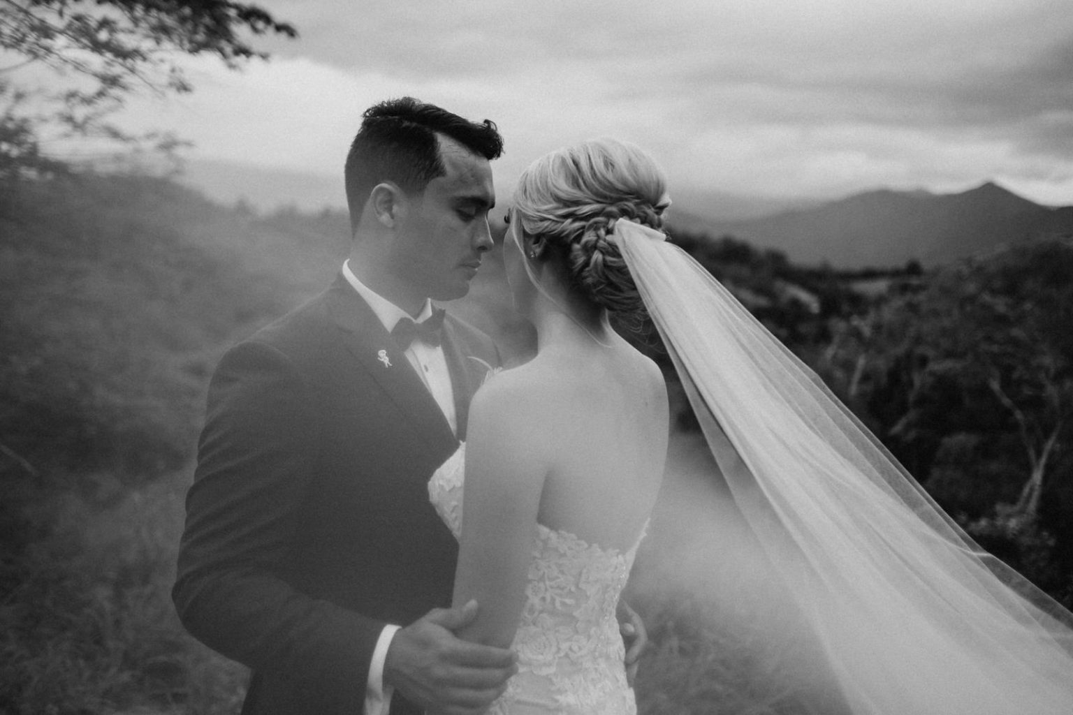 Couple on their wedding day in Brisbane embraced in intimate moment on mountain top.